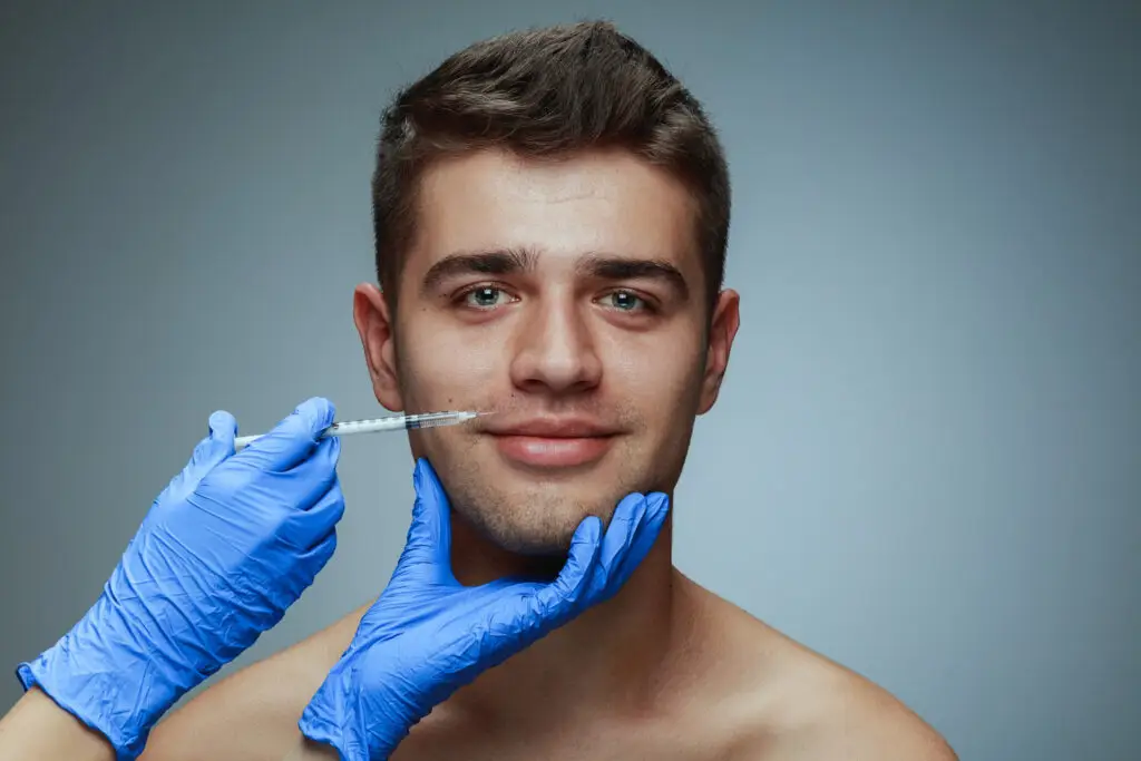 Man getting botox injection above lip