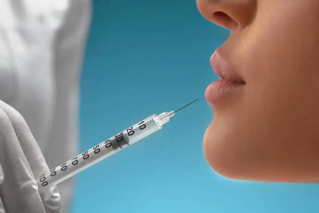 woman receiving filler injection in her lip